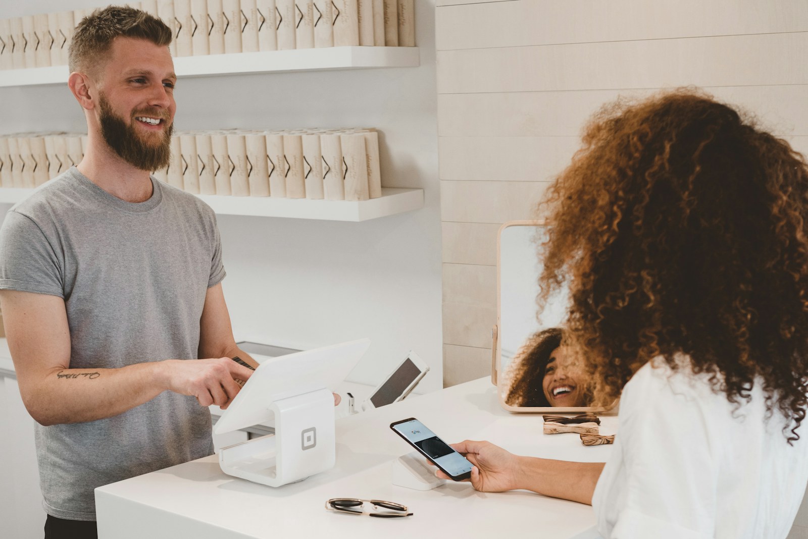 Small-business professional helping a customer at a counter